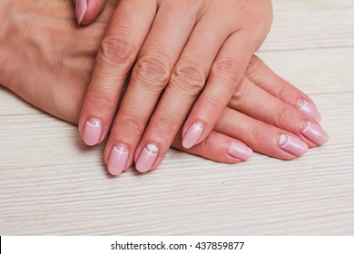 White And Pink Nail Art On The Wooden Background