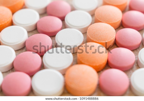 White, pink and orange tablets stripes background.\
Different Antacids medications help neutralize stomach acid.\
Antacid Oral : Uses, Side Effects, Interactions, Risks, Warnings.\
Selective focus