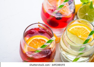 White, pink and red sangria with fruit and ice. Summer alcohol drink.