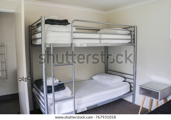 white plain bunk bed in\
dormitory