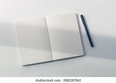White plain diary or blank journal for writing memo, note and message. Sketchbook or booklet with open page for business, studying, or learning. Notebook mock up design concept for office or lifestyle