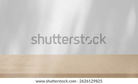 white plain wall background texture with shadow of window from sunlight and perspective wood table shelf for ads and advertisement product such as cosmetic or content or goods design display concept