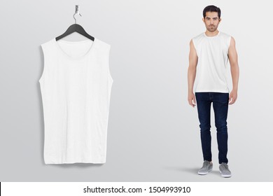 White Plan Sleeveless Shirt On A Man Male Model In Black Denim Jeans Pant, Isolated, Mockup. Hanging White Blank Sleeveless Shirt Shirt, Against Empty Wall.