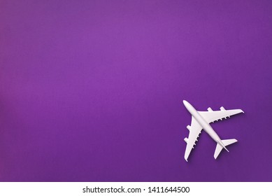 White plane, airplane on violet color background with copy space. Top view, flat lay. Minimal style design. Travel, vacation concept. - Powered by Shutterstock