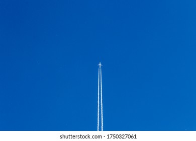 White Plane Flies In The Blue Sky