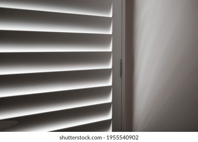 White plantation shutters in bedroom