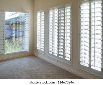 White plantation style wood Shutters for luxury Interior Design in condo.