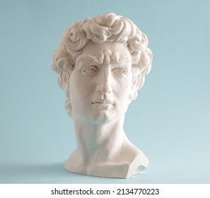 White plaster statue head of David on pastel blue background. Minimal art poster. - Shutterstock ID 2134770223