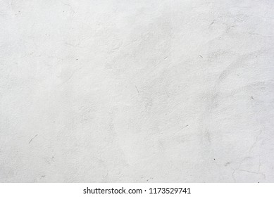 White Plaster Whitewash Wall Horizontal Background With Daubs And Fractures