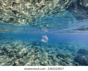 White plastic bag floating in the sea. Environmental pollution