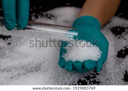 White plastic beads on black background, Polymers bead or polymer resin, polymer pallet, Product from petrochemical plants. granules polymer, [[stock_photo]] © 