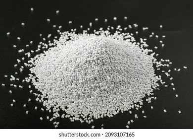 White Plastic Beads On Wood  Background, Polymers Bead Or Polymer Resin, Polymer Pallet, Product From Petrochemical Plants. Granules Polymer,