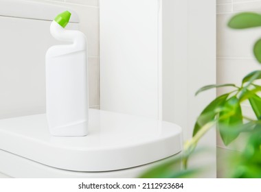 White plastic bottle with bathroom disinfectant gel on toilet bowl - Shutterstock ID 2112923684