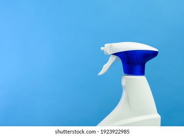 White Plastic Bottle With Spray And Foam Nozzle With Detergent On Blue Background, Copy Space