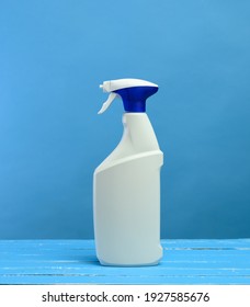 White Plastic Bottle With Spray And Foam Nozzle With Detergent On Blue Background, Close Up