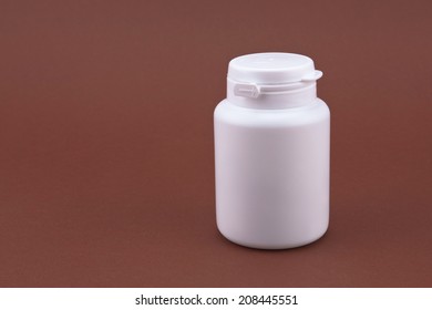 White Plastic Box With Chewing Gum On A Brown Background