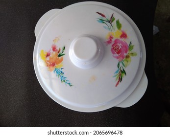 a white plastic container with a colorful flower pattern