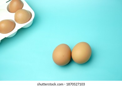 White Plastic Egg Tray With Eggs On Blue Background                  