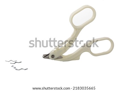 White plastic extractor skin staple remover isolated on white background.
