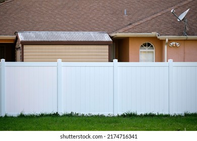 White plastic fence for back yard protection and privacy - Shutterstock ID 2174716341