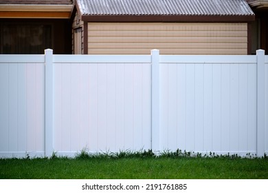 White plastic fence for back yard protection and privacy - Shutterstock ID 2191761885