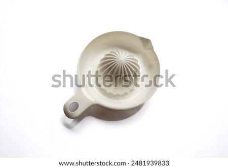 White plastic lemon squeezer on white background
