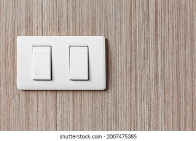 White Plastic Light Switch At The Head Of The Bedroom Bed