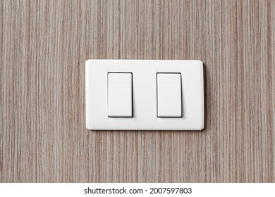 White Plastic Light Switch At The Head Of The Bedroom Bed