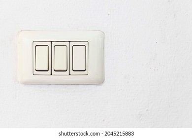 White Plastic Light Switch At The Head Of The Bedroom Bed