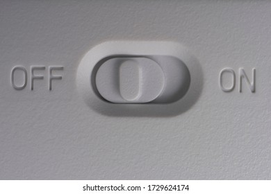 White plastic power button. Close-up. Free space for an inscription.