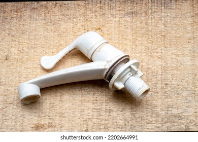 White Plastic Sink Faucet On Wood Background