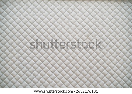 white plastic surface with embossed diamond pattern                              