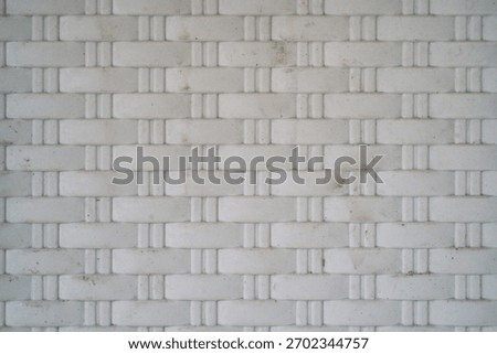  white plastic surface with embossed woven pattern                           