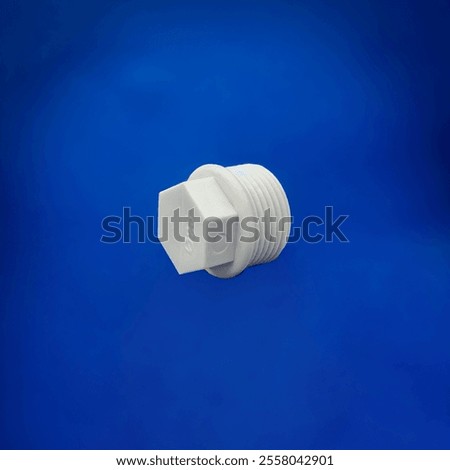 A white plastic threaded plug designed to seal pipe ends with precision.