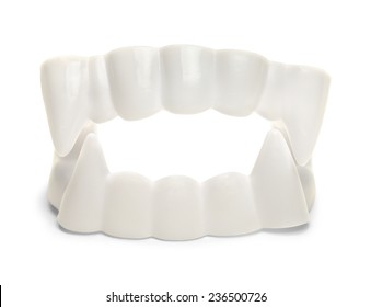 White Plastic Vampire Teeth Isolated On White Background,