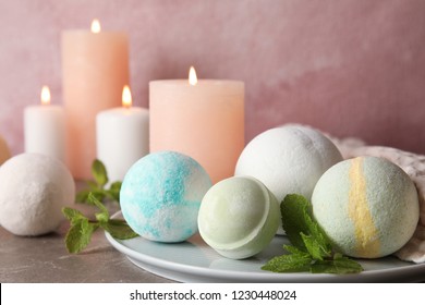 White plate with bath bombs and mint leaves on table