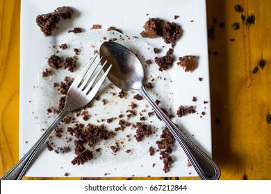 A White Plate With Crumbs After Finished Eat Sweet Cake