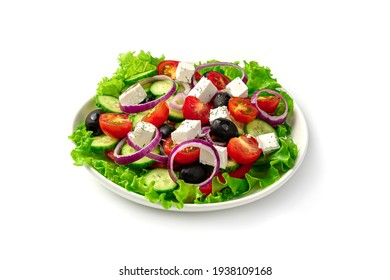 White plate with fresh Greek salad isolated on a white background. Side view, close-up.