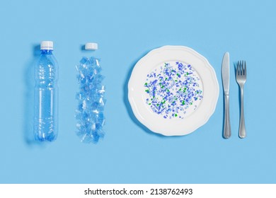 White plate full of microplastics on blue background with copy space. Plastic pollution concept, global ocean pollution ecology problem, microplastic particles in water and food, top view, flat lay