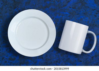 White Plate And Mug Mockup On Blue Background. Empty Tableware Mockup For Presentation And Design Promotion