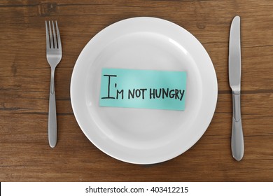 White Plate With Words I'm Not Hungry On Wooden Background