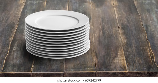 White Plates Stacked On Brown Wooden Table