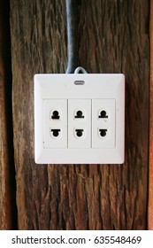 A White Plug Socket Outdoor On The Wood