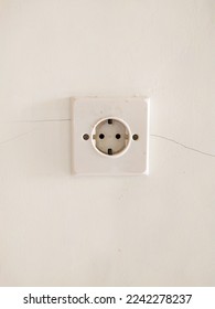 White plug at white wall