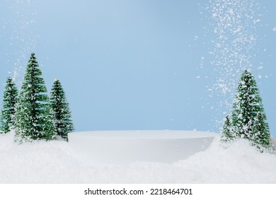 White podium with fir trees and falling snow. Display for winter holidays, New Year and Christmas product presentation - Shutterstock ID 2218464701