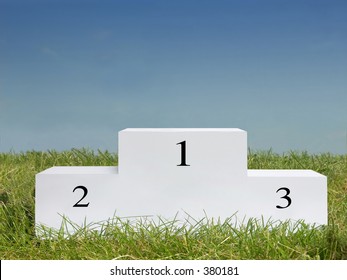 White podium on the grass against clear blue sky - Shutterstock ID 380181