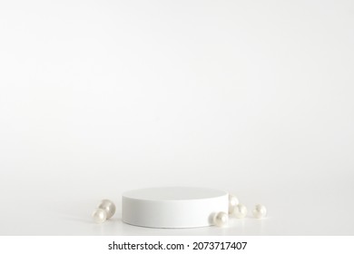 White Podium With Pearls On The White Background, Simple Geometric Form. Podium For Product, Cosmetic Presentation. Creative Mock Up. Pedestal Or Platform For Beauty Products.