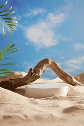 A White Podium In Round-shaped Displayed On The Sand With A Big Tree Branch And Some Green Tropical Leaves. Blue Sky Background