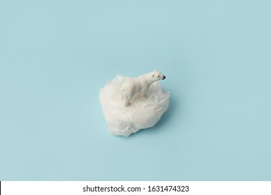 White Polar Bear On Plastic Bag On Blue Background, Plastic Pollution And Climate Change Concept