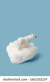 White Polar Bear On Plastic Bag On Blue Background, Plastic Pollution And Climate Change Concept